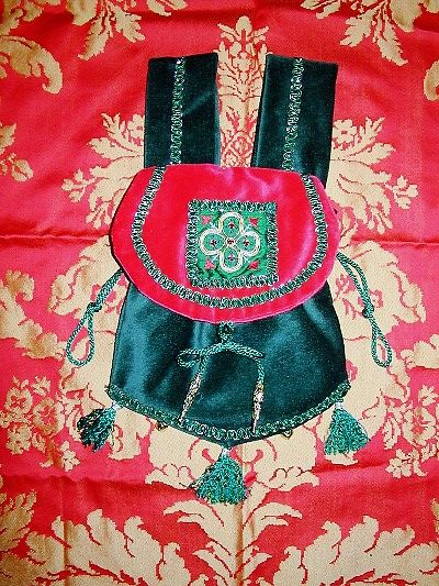 Red and green velvet pouch with quatrefoil goldwork and silkwork with jewels reproduced from a brooch on the throat of figure in a Fresco in Westminster Palace