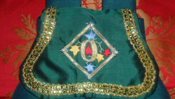 Detail of Lombardic Text of the Letter 'O' in Goldwork and Silk Shading with Freshwater Pearls, Plate braid, Bronze Spangles and tiny Green Seed Beads