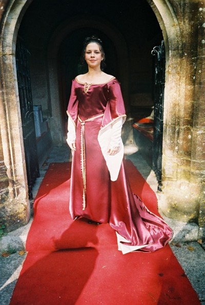 Shelley Trowt in burgundy duchess satin wedding dress, lined in white silk with gold metallic braid